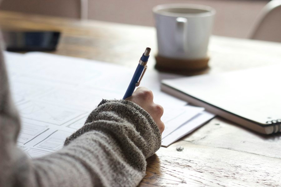 Person completing onboarding forms at a desk